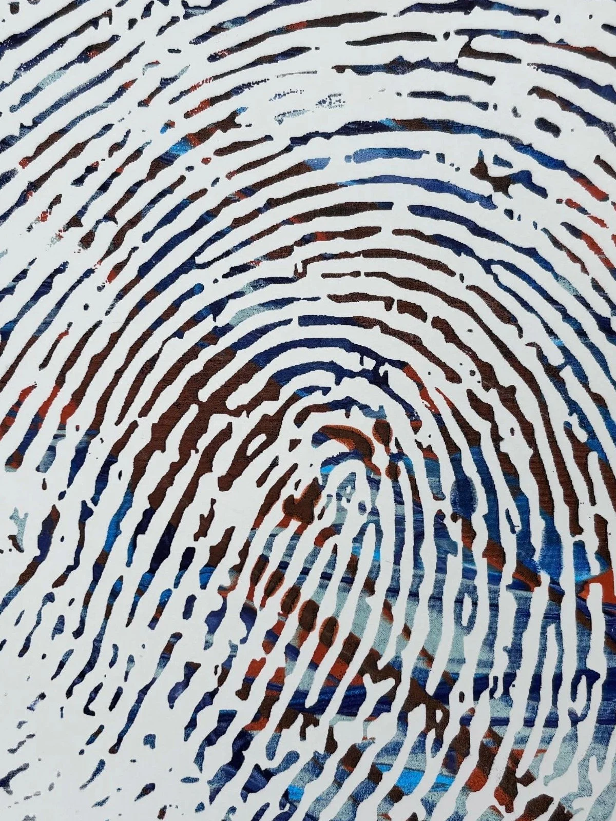 Close-up of a printed fingerprint with ink smudges in shades of brown, black, blue, and red.