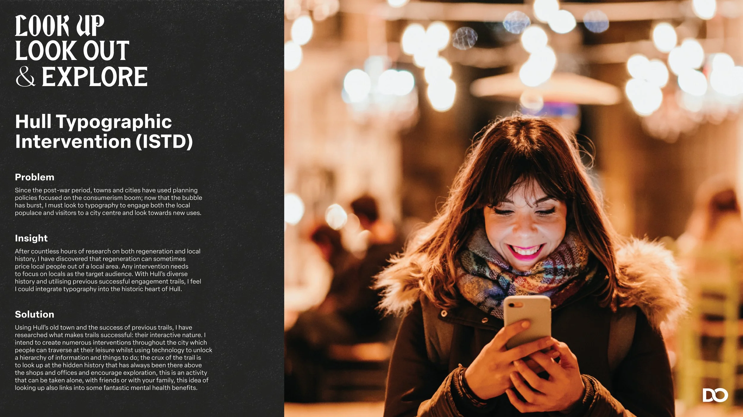 A smiling woman with brown hair and a colorful scarf looks at her phone while walking in a city street at night, with blurred city lights in the background.