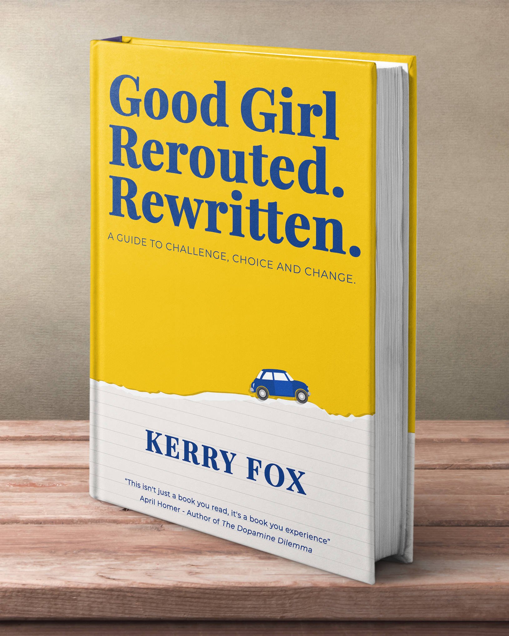 A yellow hardcover book titled 'Good Girl Rerouted. Rewritten.' by Kerry Fox is standing upright on a wooden surface against a plain background.