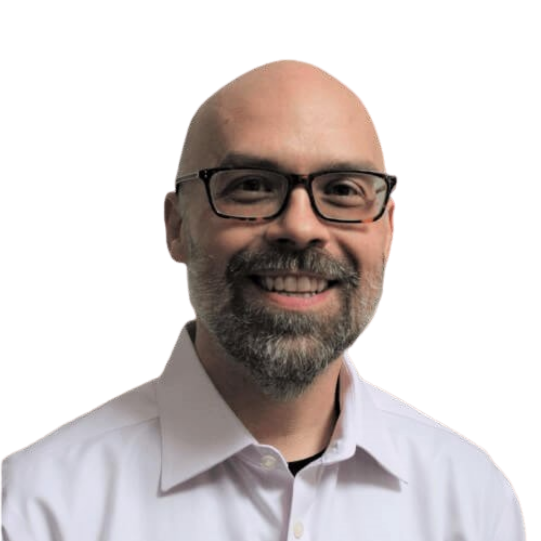 Professional headshot of a smiling bald man with glasses and a grey beard, wearing a white collared shirt