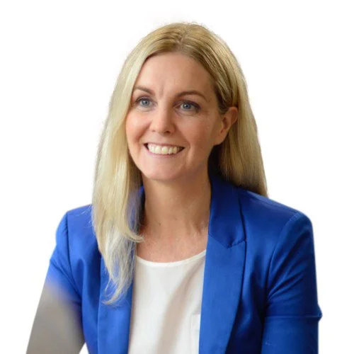 Professional portrait of a smiling woman with long blonde hair, wearing a bright blue blazer over a white top against a white background