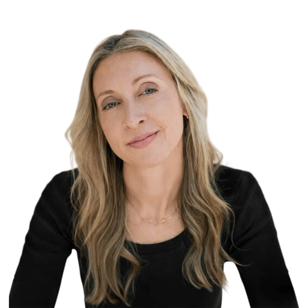 A woman with long blonde hair looking at the camera in a black long sleeved top