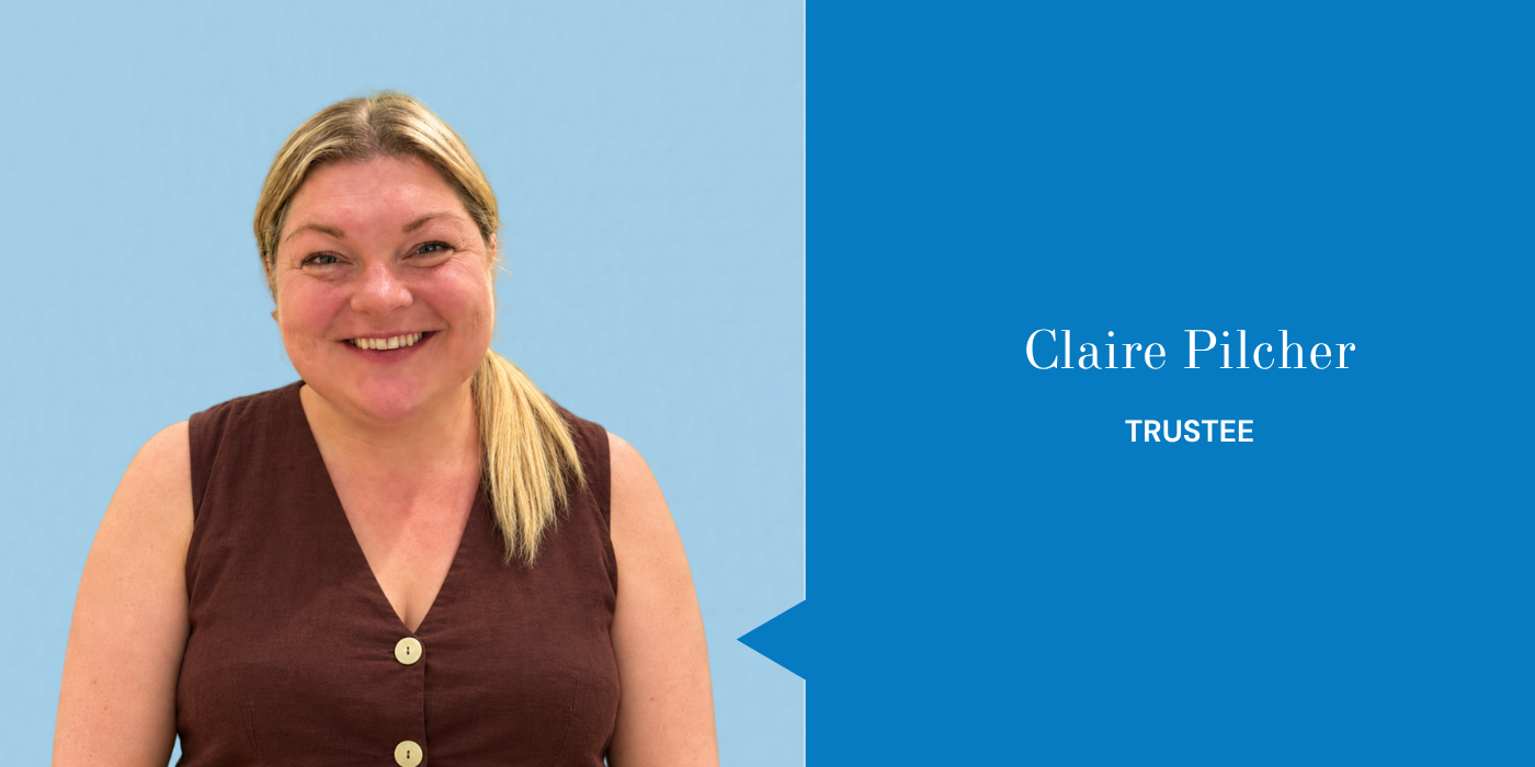 Headshot of a smiling woman with blonde hair in a ponytail, wearing a sleeveless brown top, on a blue background with a blue nameplate that reads 'Claire Pilcher, Trustee'.