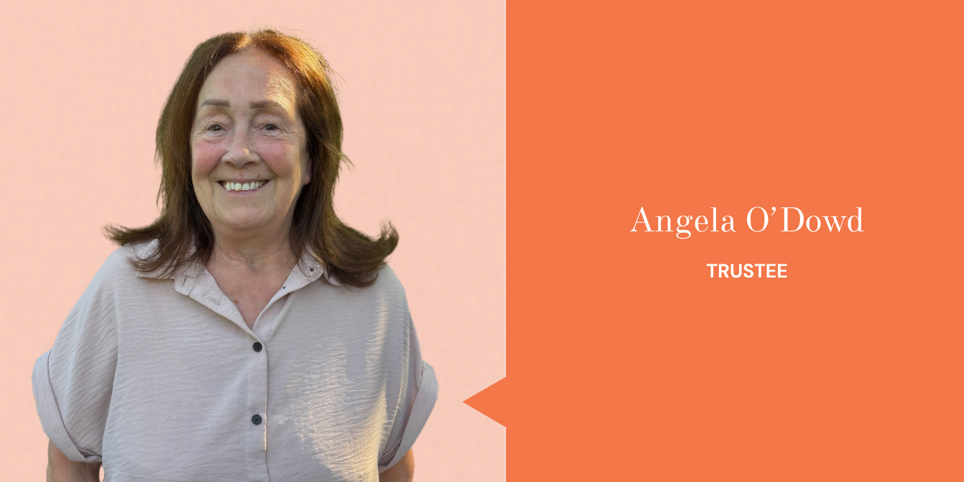 Photograph of Angela O'Dowd smiling, wearing a beige shirt, with a light pink background. On the right side, a graphic displaying her name and title as Trustee on an orange background.