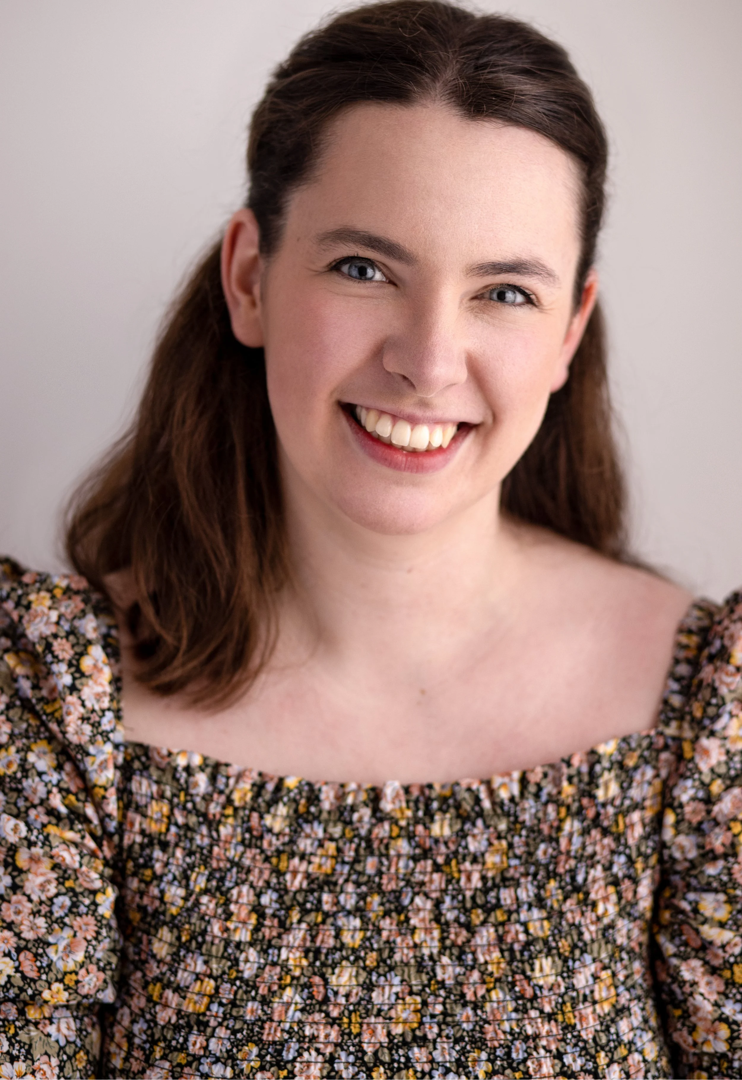 Headshot of Alys Betsan Jones wearing a floral top