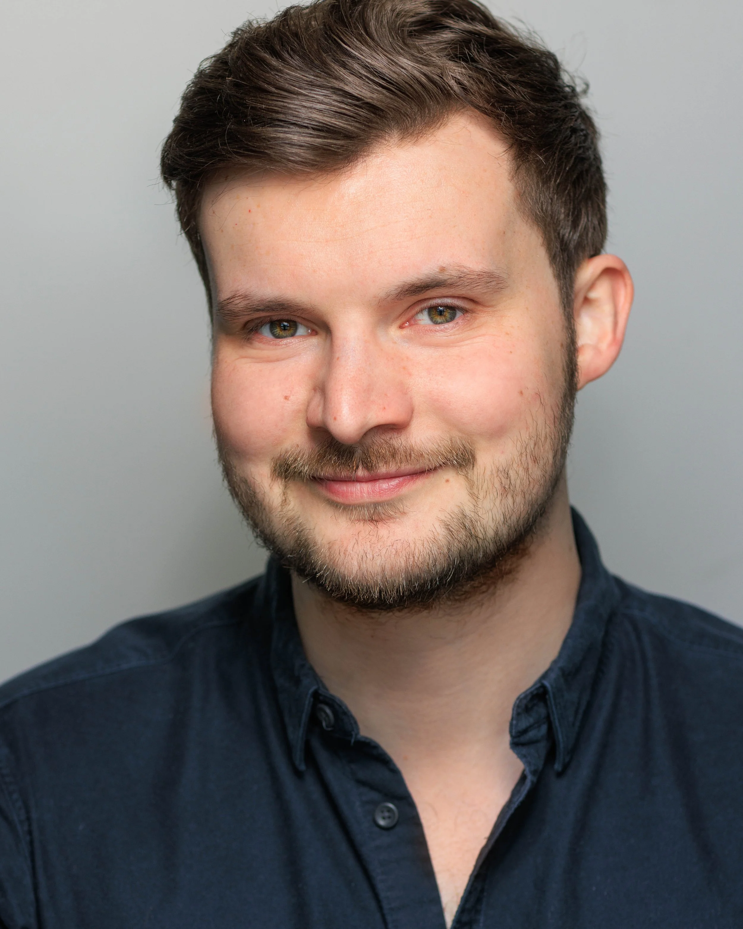 Headshot of Hames Hall wearing a navy blue shirt