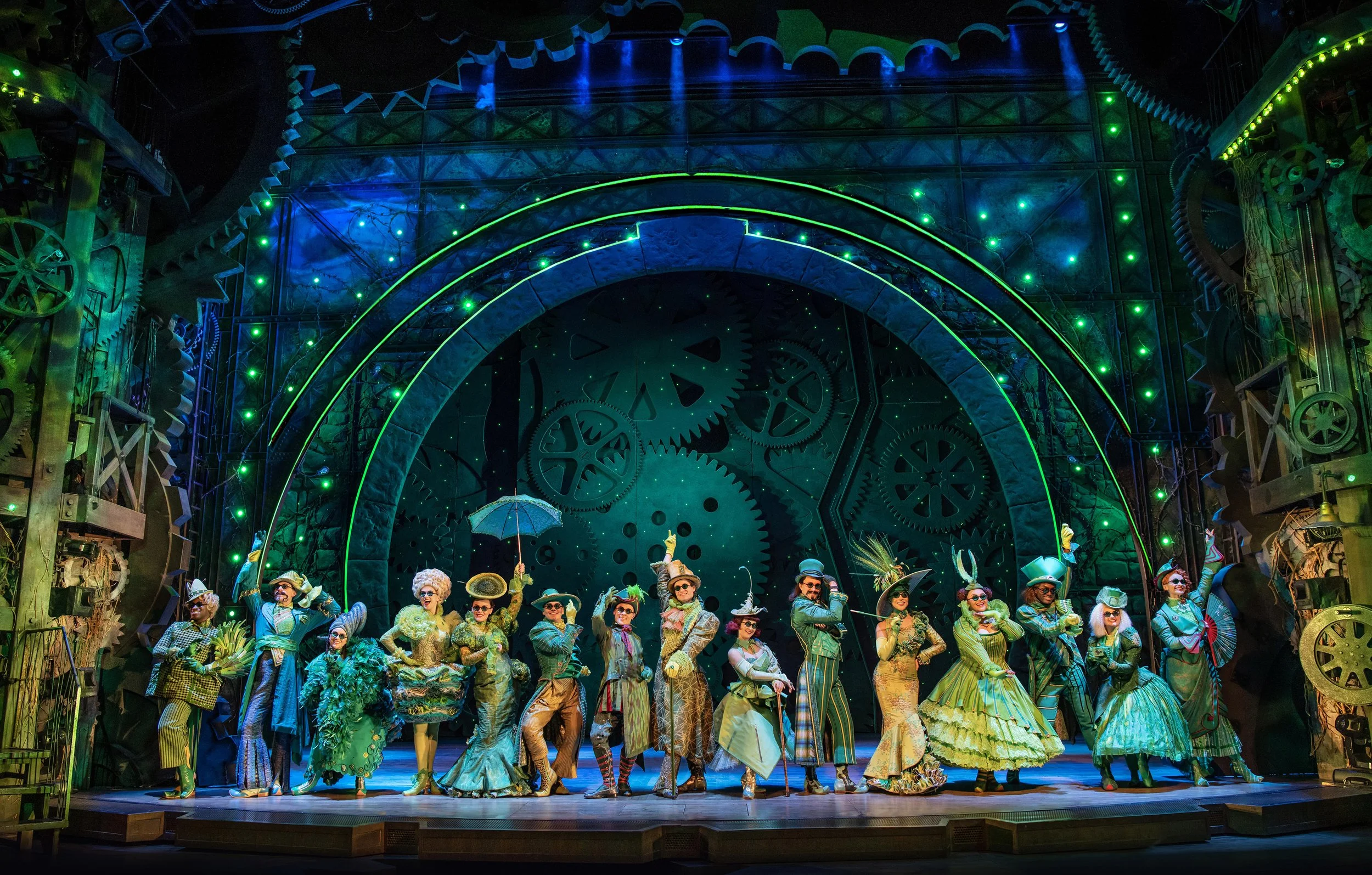 Ozians from the musical Wicked dressed in green, posing in Emerald City
