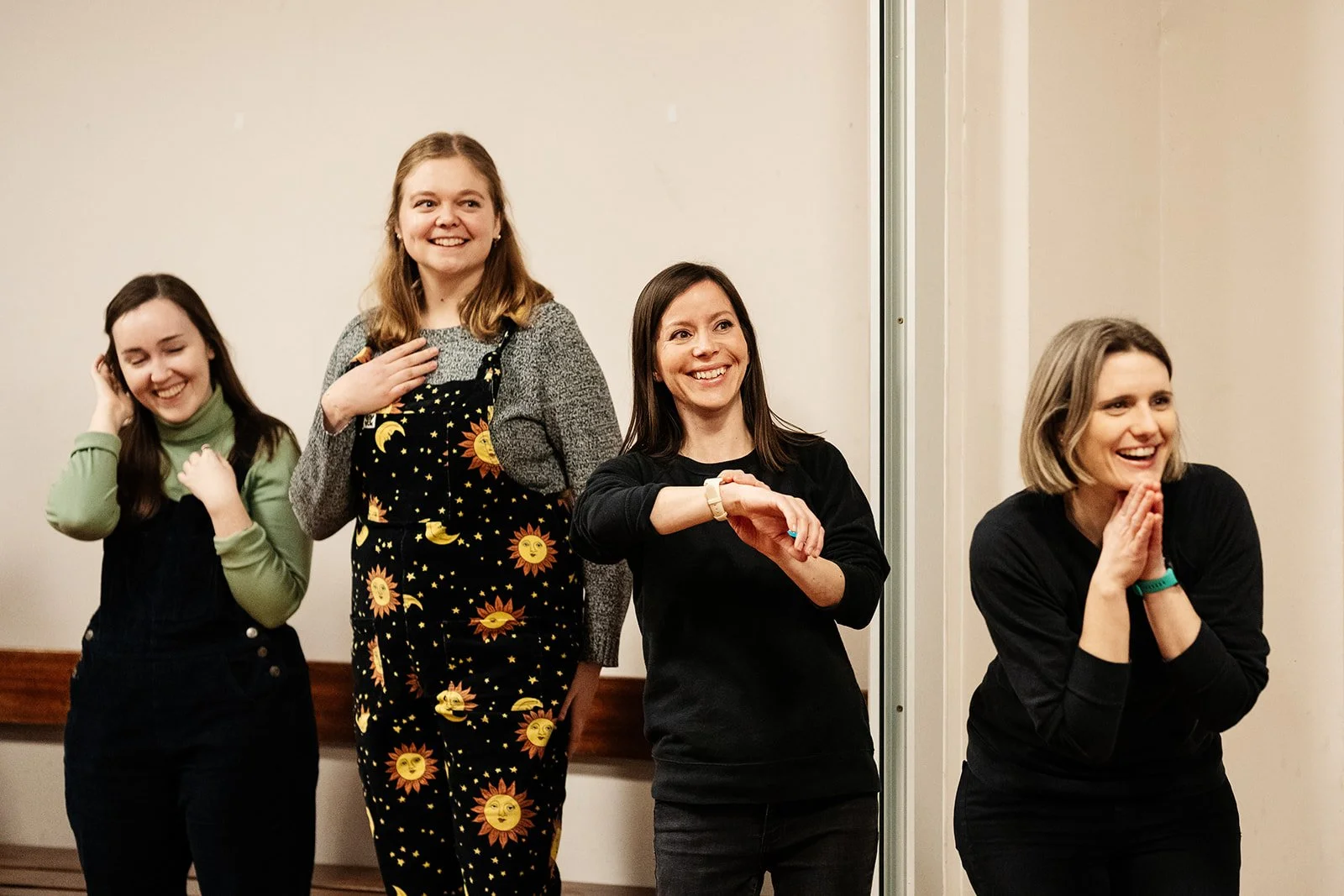 Participants laugh with the Starling Arts team during a workshop