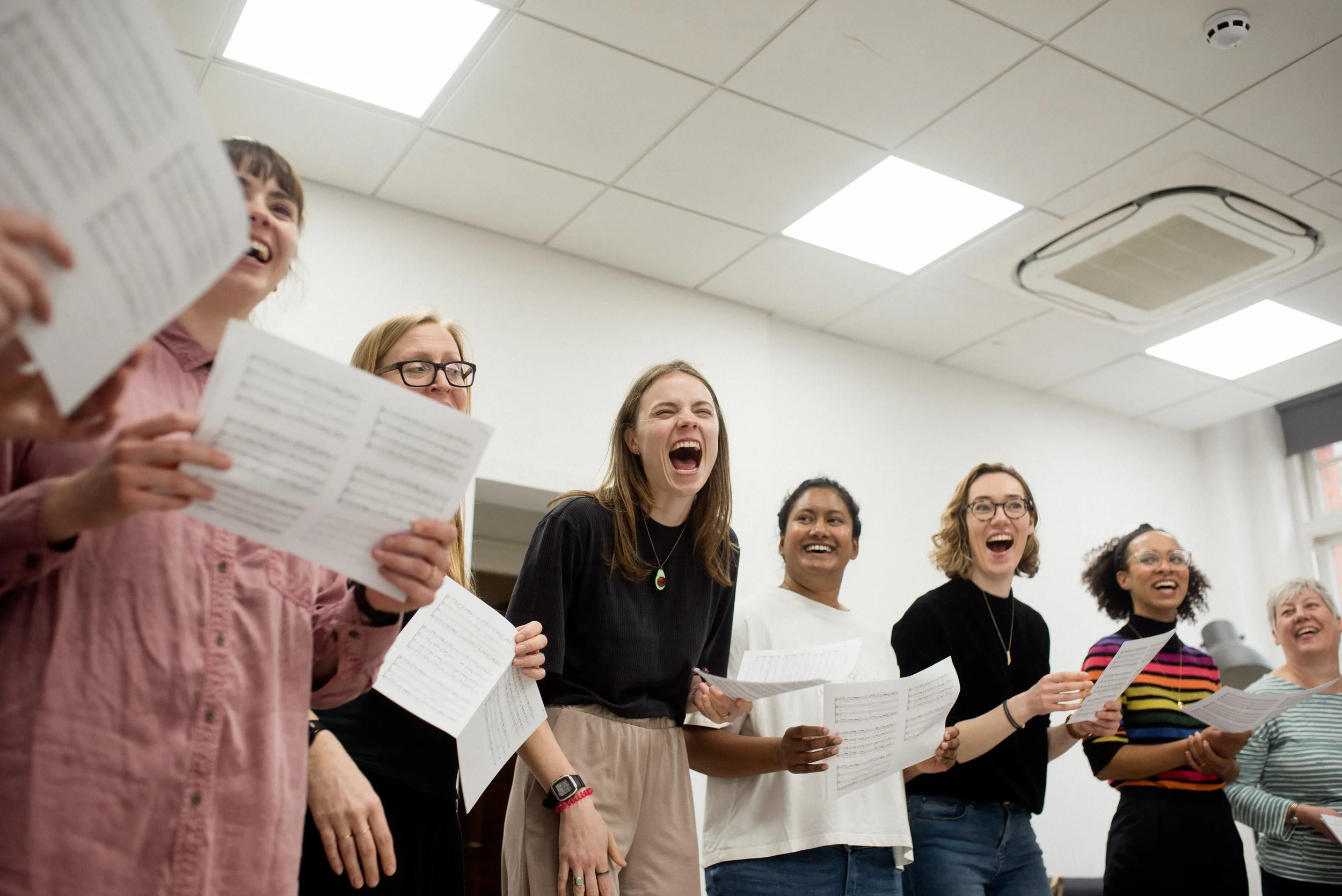 Members of Flock share a joke during a rehearsal