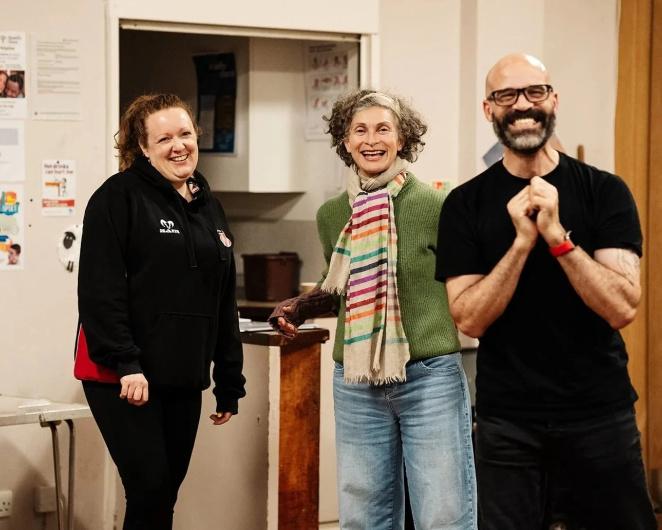 Three people laugh in a Starling Arts workshop.