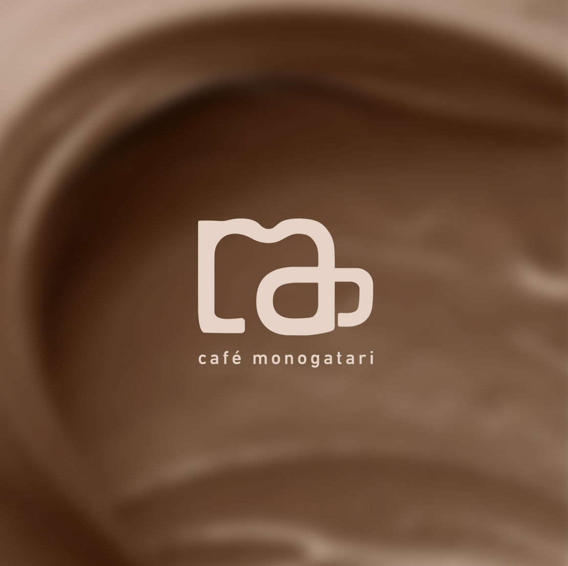 Logo of Café Monogatari with a stylized coffee cup icon and the text 'café monogatari' on a blurred brown coffee background.