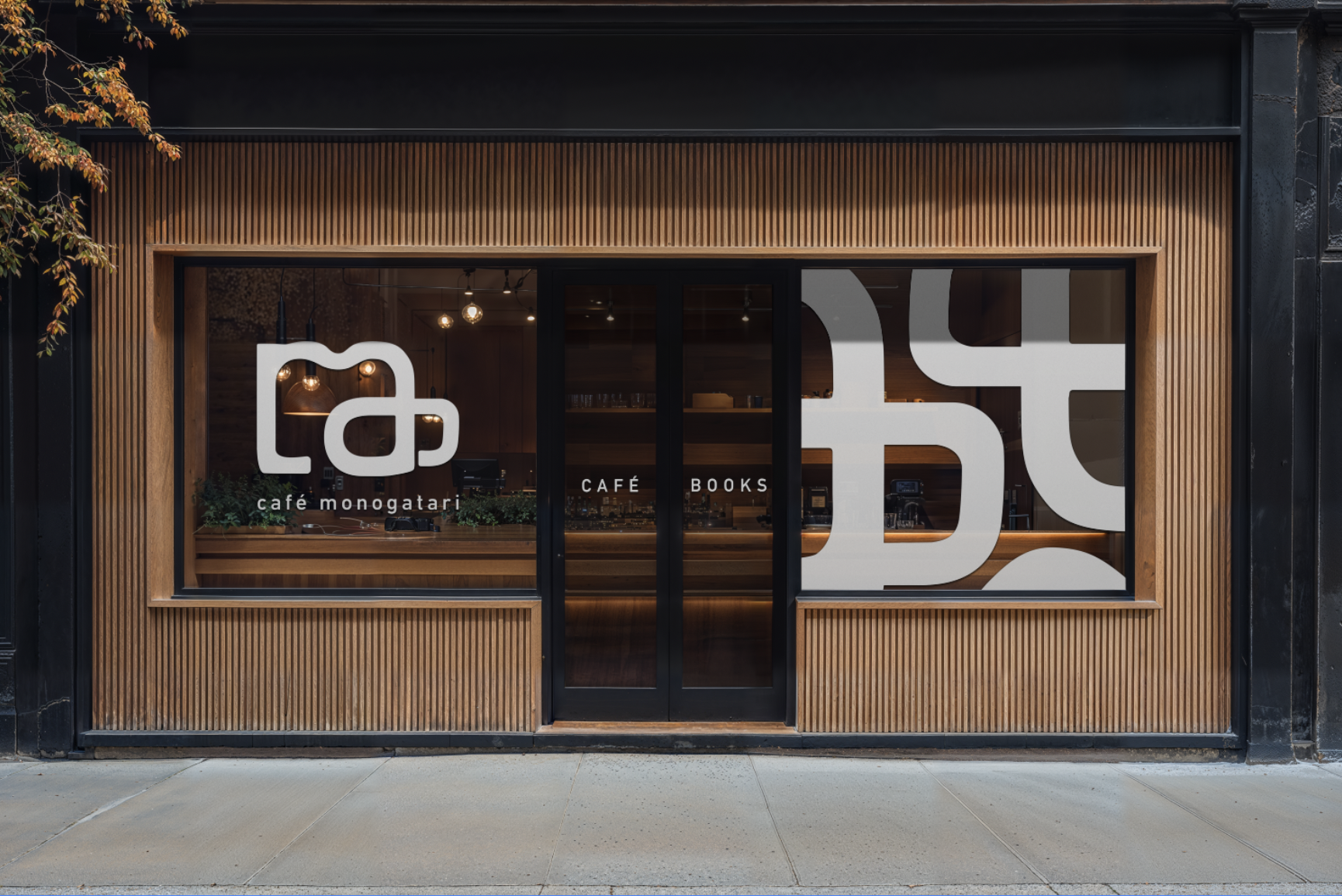 Modern cafe storefront with wood paneling, large front windows, and minimal lettering reading 'café monogatari' and 'Café Books'.
