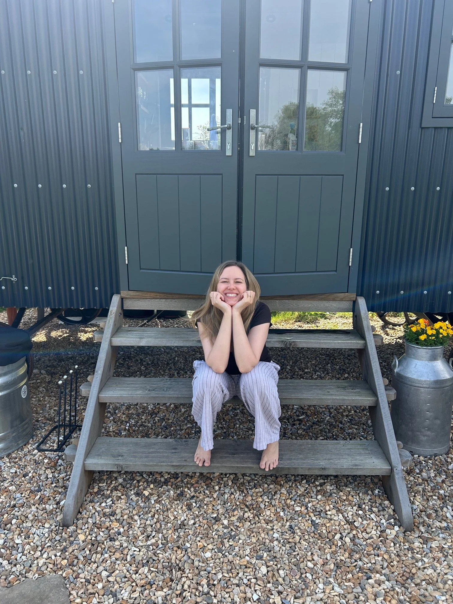 Warm and friendly yoga teacher smiling at students after outdoor yoga session.