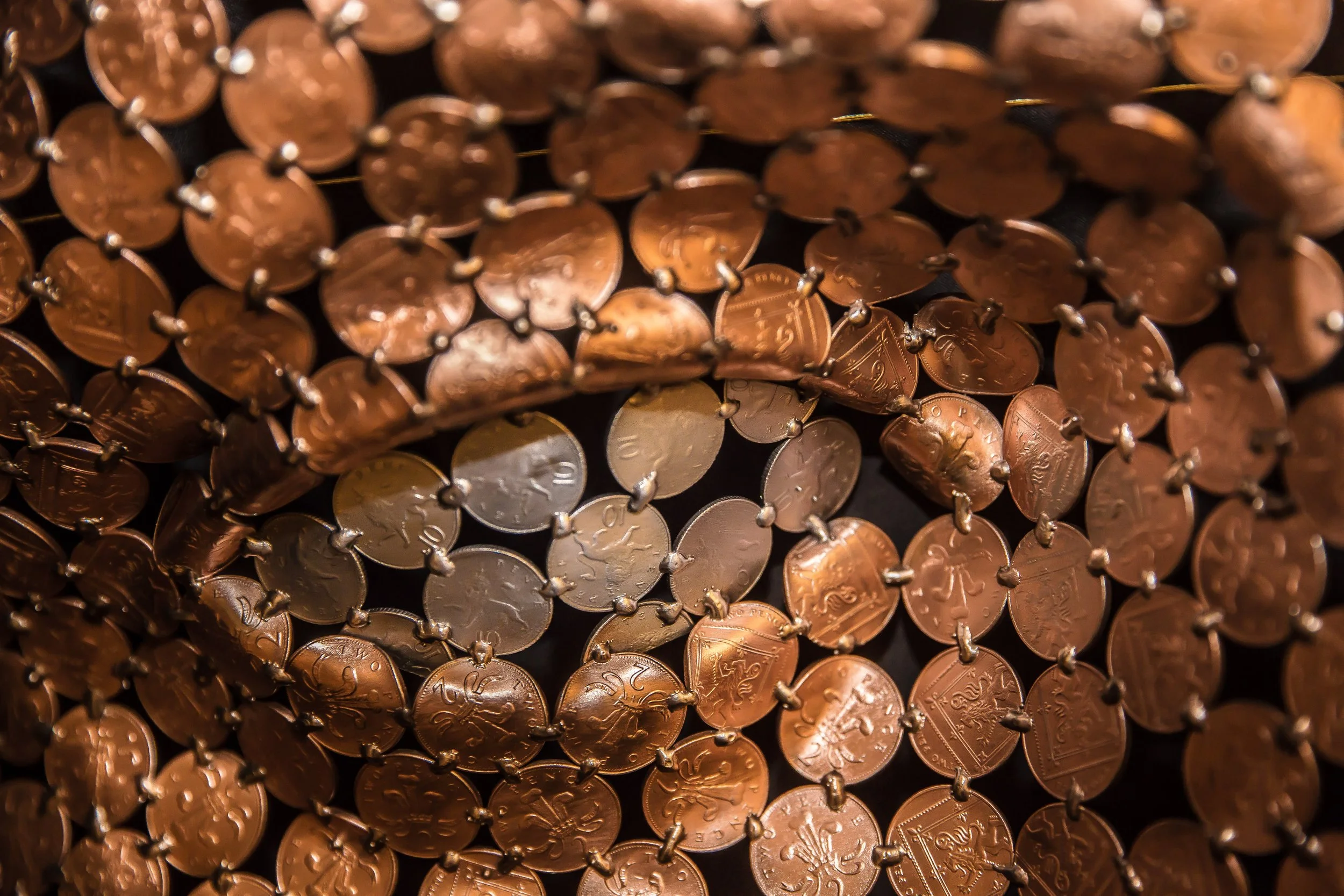 Face sculpture by Shaun Gagg made by welding about 1,000 2p coins, light enough to hang on a wall. The eyes can be customized using 1p, 2p, 5p, or 10p coins.