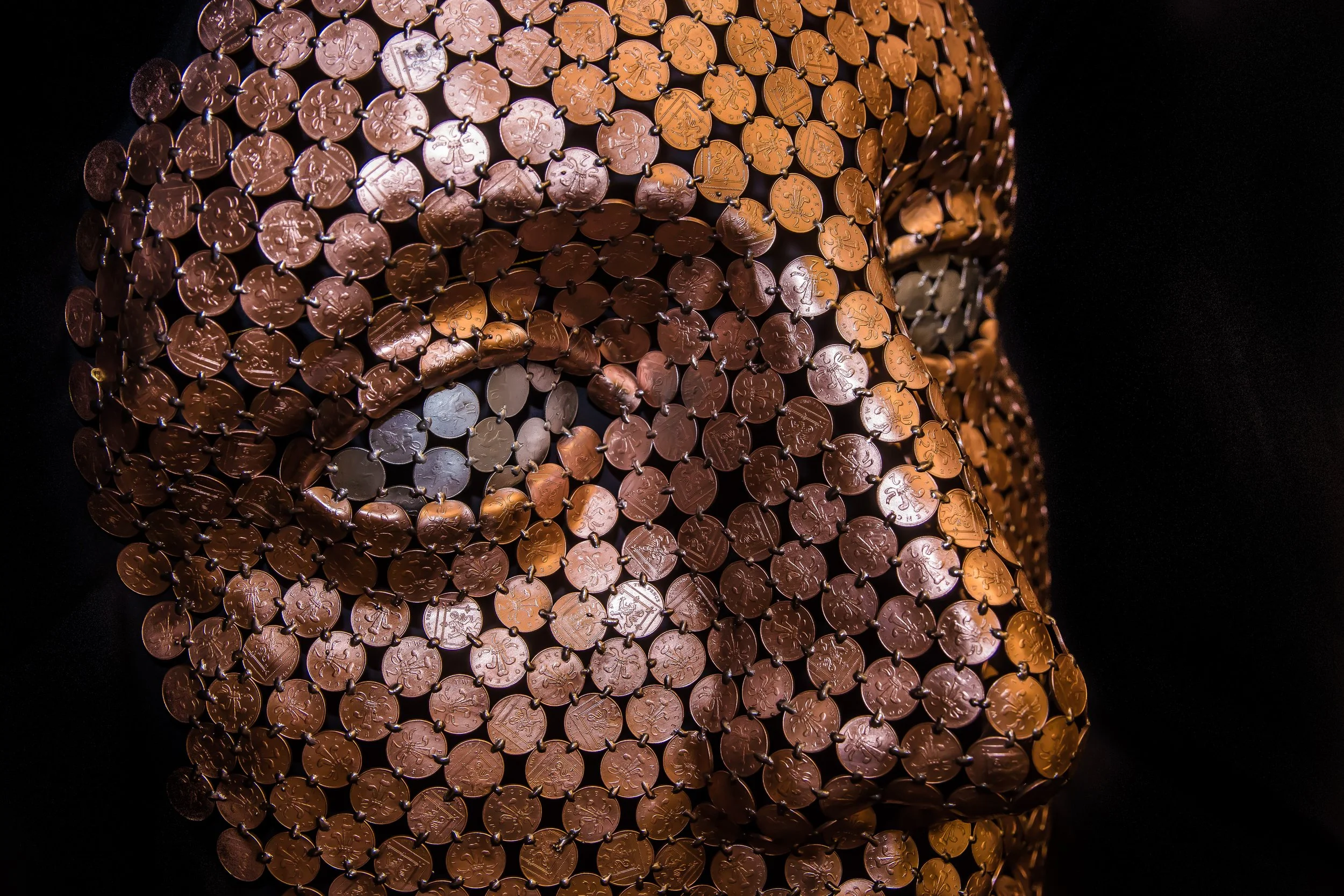 Face sculpture by Shaun Gagg made by welding about 1,000 2p coins, light enough to hang on a wall. The eyes can be customized using 1p, 2p, 5p, or 10p coins.