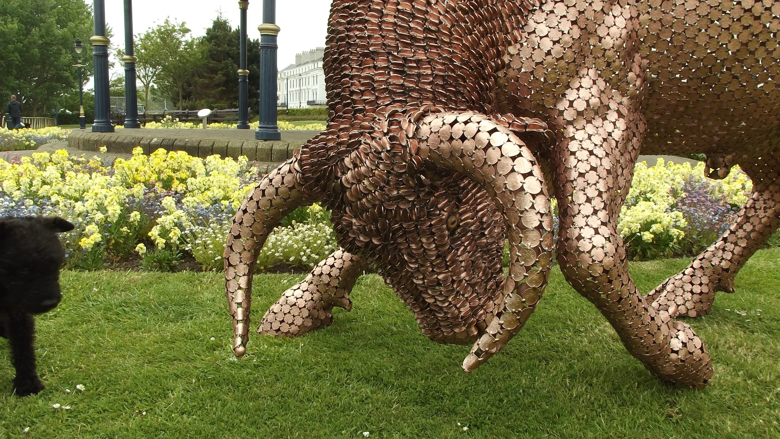 Shaun Gagg's sculpture shows a bull in a charging stance, head lowered and horns forward. Made of tightly arranged two pence coins, it captures strength and motion.