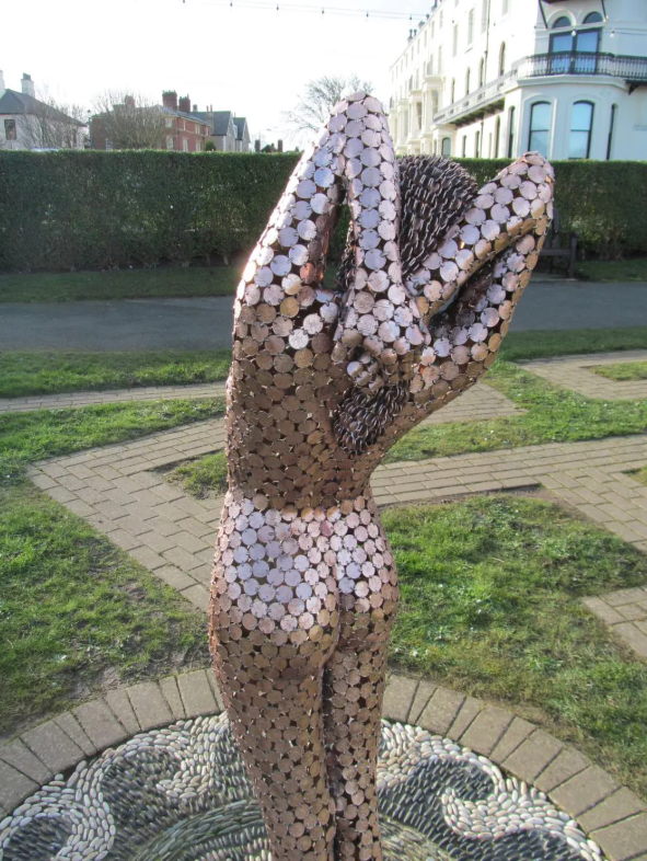 life-size sculptures of a woman by Shaun Gagg, crafted entirely from 2p coins. This striking piece intricately explores themes of value and femininity through its unique coin construction.