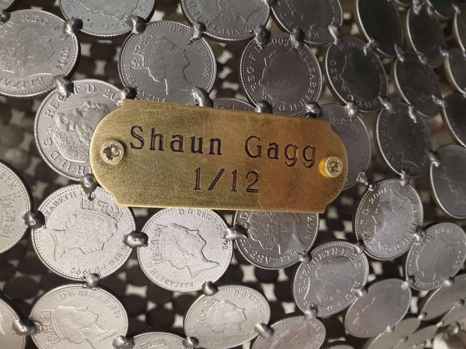 A 10P Jaguar," a life-size sculpture by Shaun Gagg, featuring a plaque that signifies the edition number, adding to the uniqueness and authenticity of this striking piece.