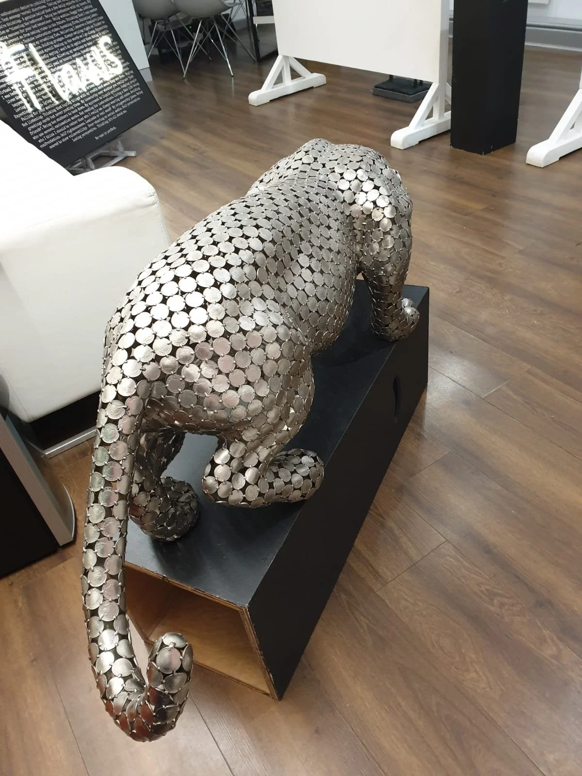 A 10P Jaguar," a life-size sculpture by Shaun Gagg made from welded 10p coins, capturing the jaguar's sleek, powerful form with intricate coin detailing.