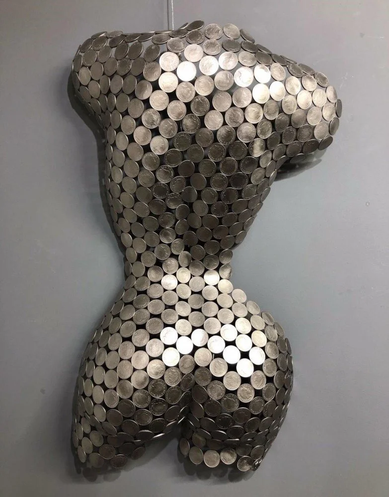 A 10P Torso Rear" by Shaun Gagg, a life-size sculpture crafted from 10p coins. It can be displayed on a base or hung on a wall, offering versatility in showcasing the detailed artistry of the piece.