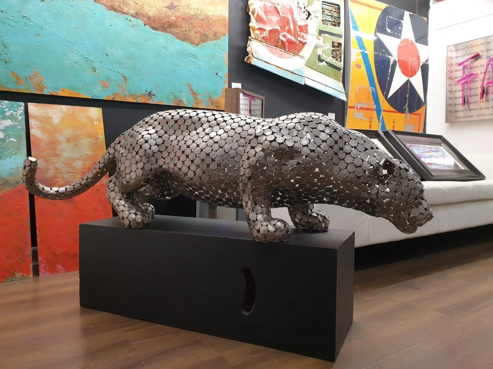 A 10P Jaguar," a life-size sculpture by Shaun Gagg made from welded 10p coins, capturing the jaguar's sleek, powerful form with intricate coin detailing.
