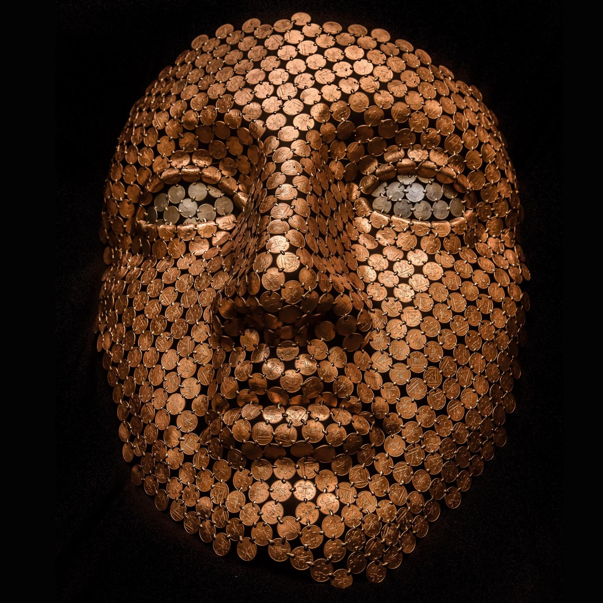 Face sculpture by Shaun Gagg made by welding about 1,000 2p coins, light enough to hang on a wall. The eyes can be customized using 1p, 2p, 5p, or 10p coins.