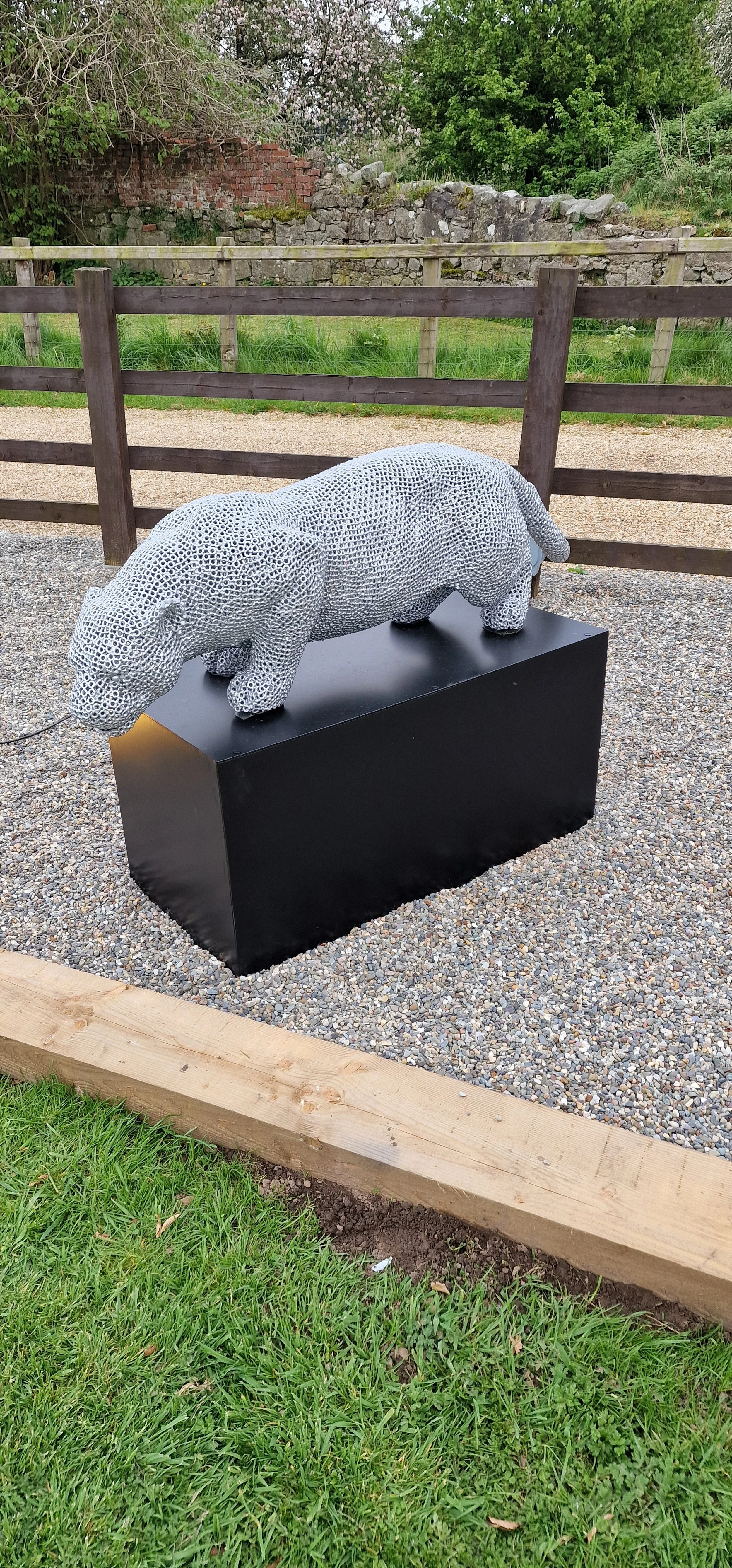 a jaguar made from over 7000 metal nuts and 17,000 individual welds it has been liquid galvanised then powder coated to a silver colour to protect it from the elements so it will not rust