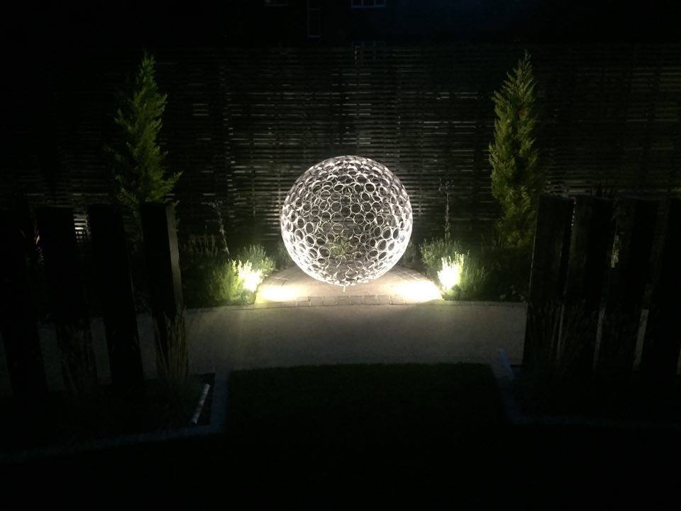 This sculpture is a sphere. Crafted by cutting steel pipes into slices and welding them together from the inside.  Note: The sphere will eventually rust over time.