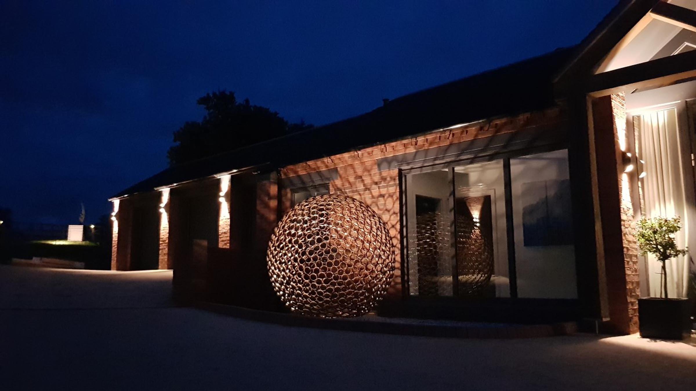 This sculpture is a sphere. Crafted by cutting steel pipes into slices and welding them together from the inside.  Note: The sphere will eventually rust over time.