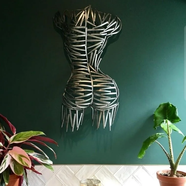 A torso sculpted from nails—sharp, textured, and raw. Suspended or grounded, it plays with light and shadow, turning metal into movement.
