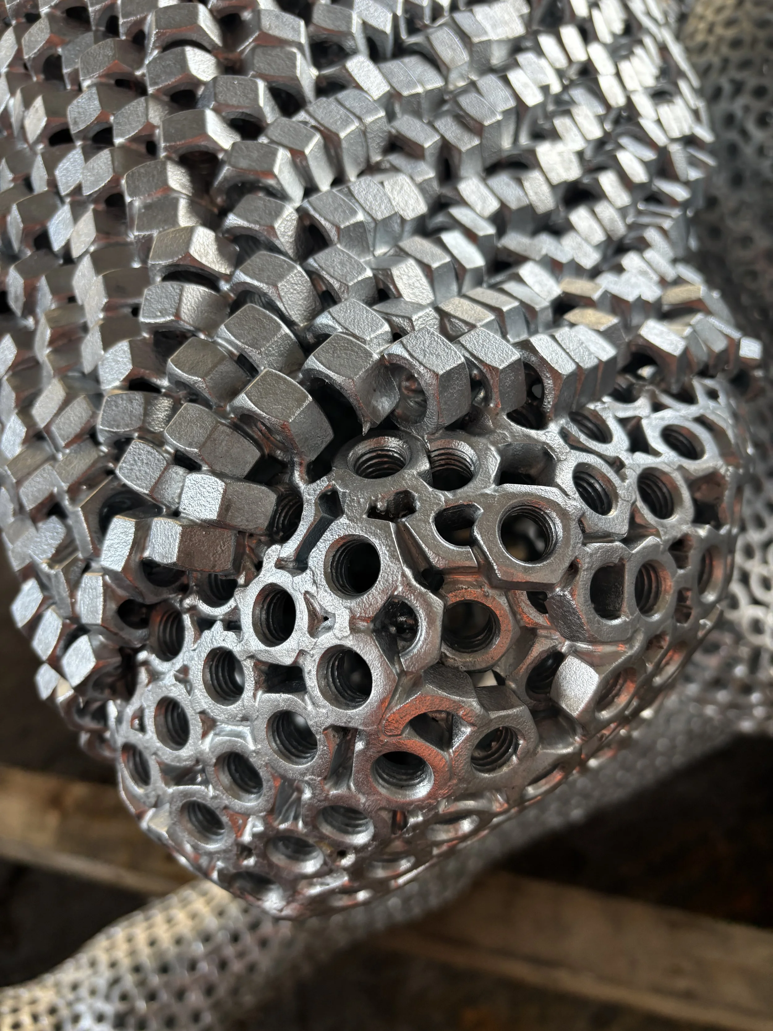 Close-up    “A detailed bull sculpture by Shaun Gagg, built from 14,000 metal nuts and over 50,000 welds, giving it a strong, textured, industrial appearance.”