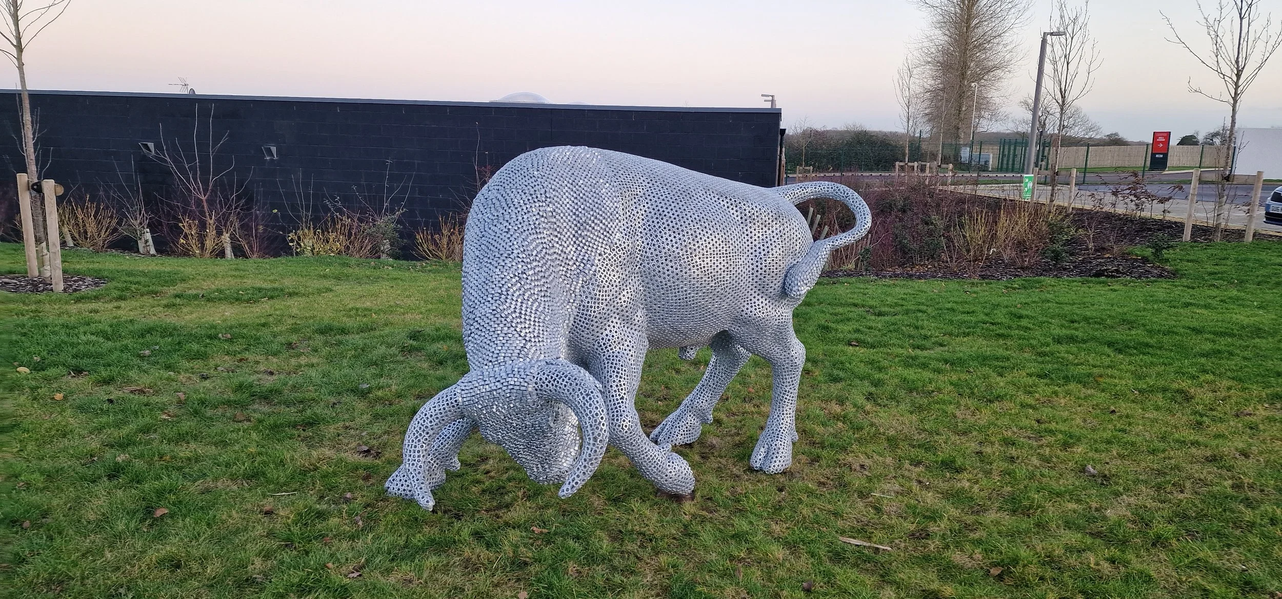 “A detailed bull sculpture by Shaun Gagg, built from 14,000 metal nuts and over 50,000 welds, giving it a strong, textured, industrial appearance.”