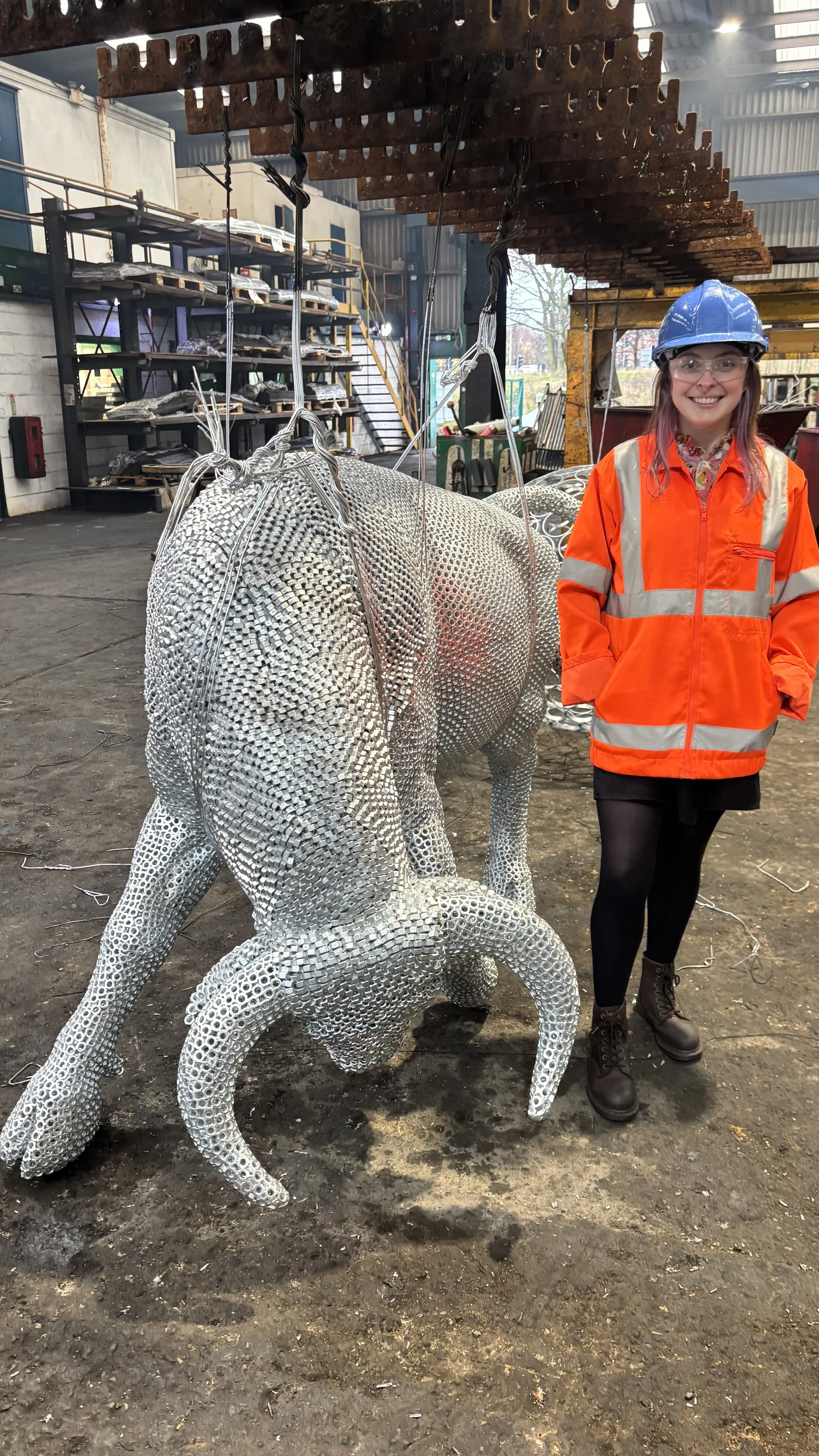 “A detailed bull sculpture by Shaun Gagg, built from 14,000 metal nuts and over 50,000 welds, giving it a strong, textured, industrial appearance.”