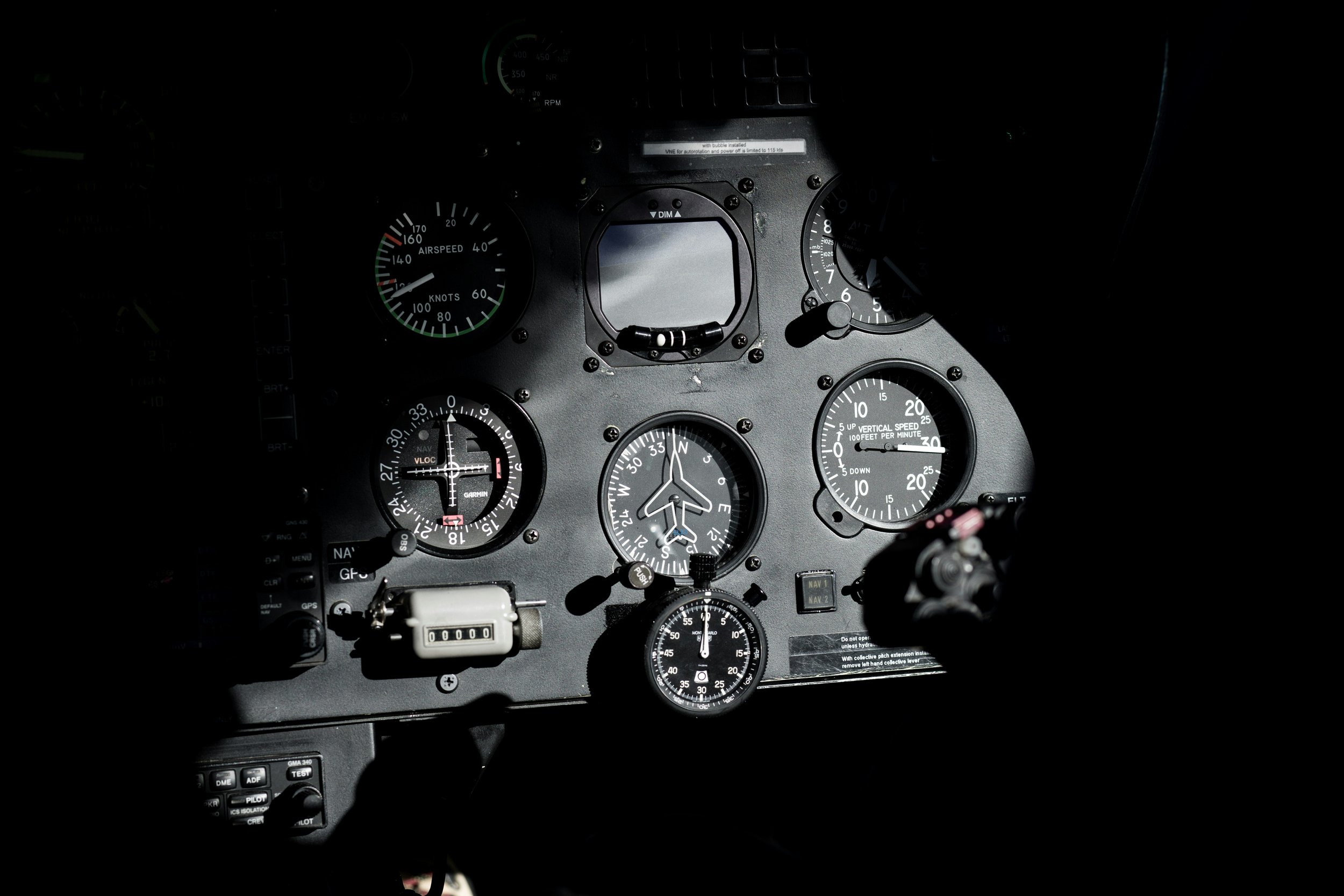 A close-up of an aircraft cockpit dashboard showing various gauges and controls, including airspeed, vertical speed, and navigation instruments.