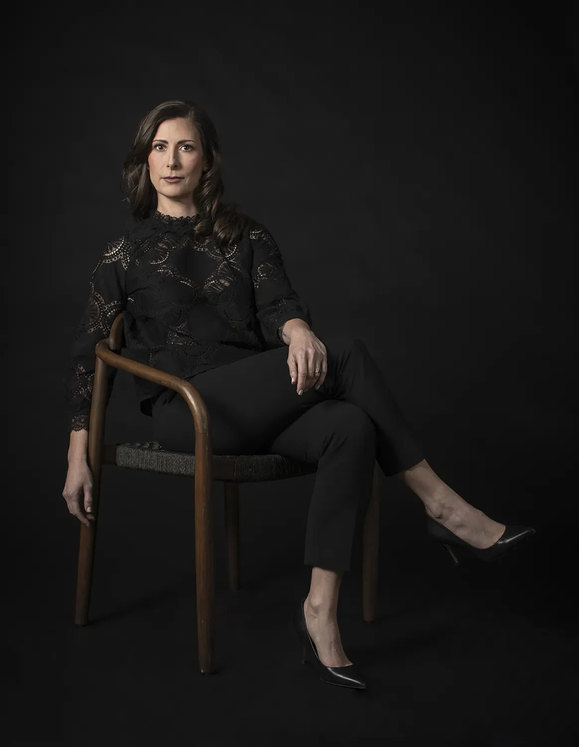 Erin Langille sitting in a chair dressed in black