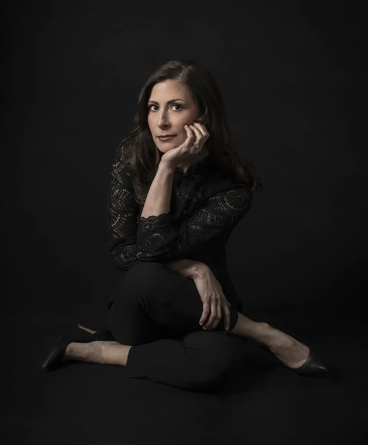 A photo of founder Erin Langille sitting with legs crossed on the floor