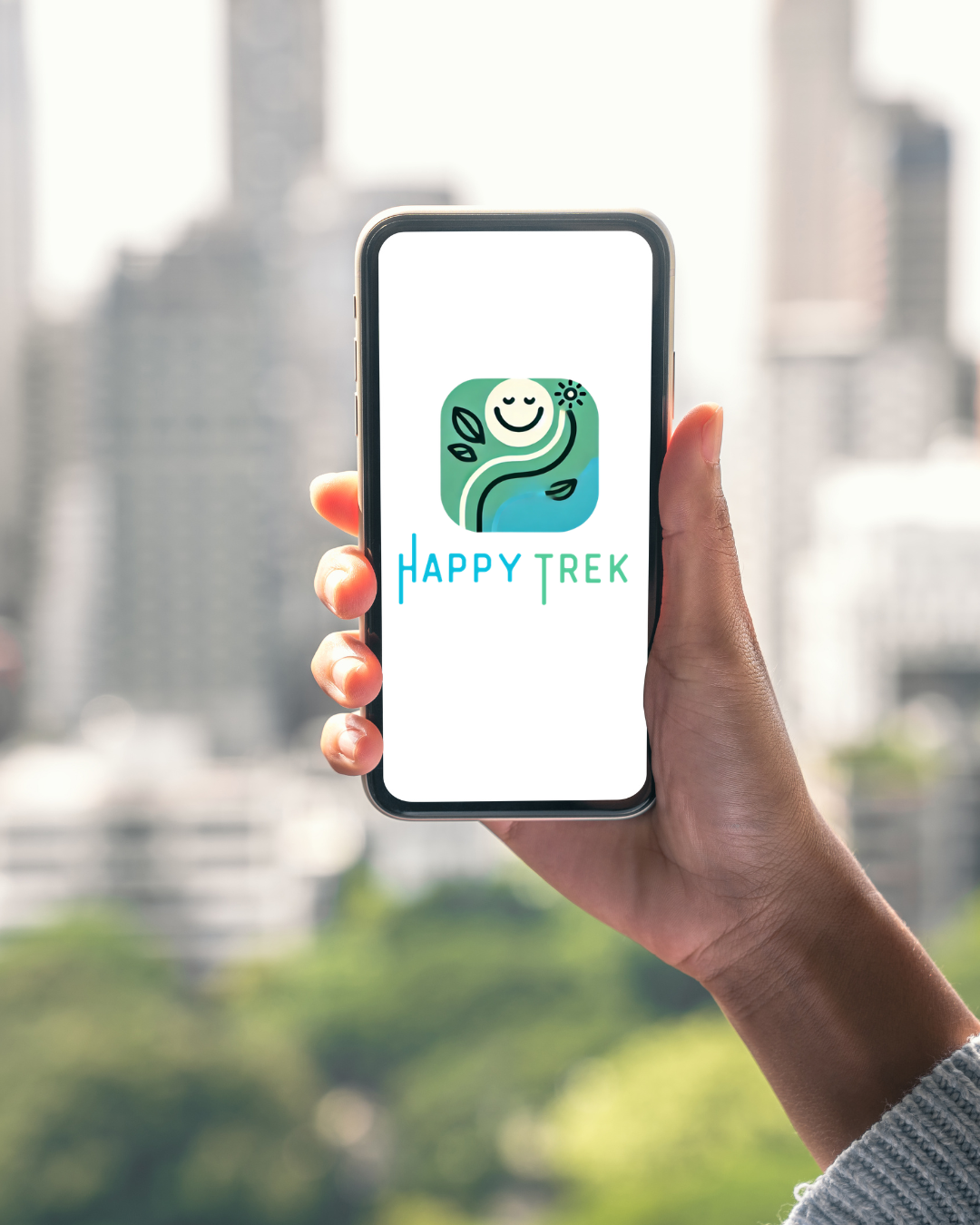 Hand holding a smartphone displaying the Happy Trek app logo with a smiling face, leaves, and a sun illustration, against a blurred cityscape background.