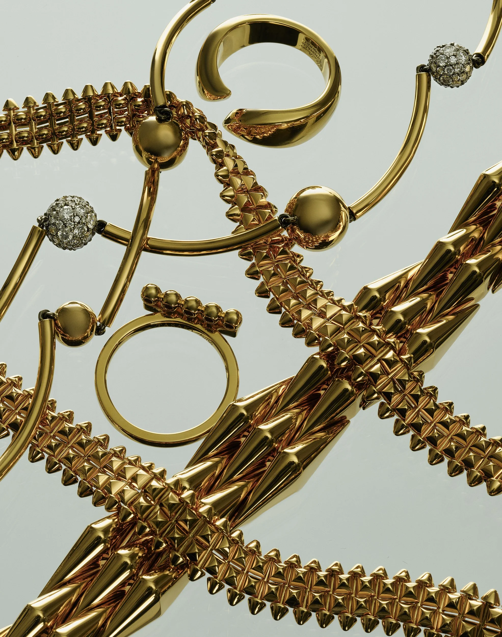 Still Life photograph by photographer Paul Zak of gold designer jewellery for Telegraph Luxury Magazine