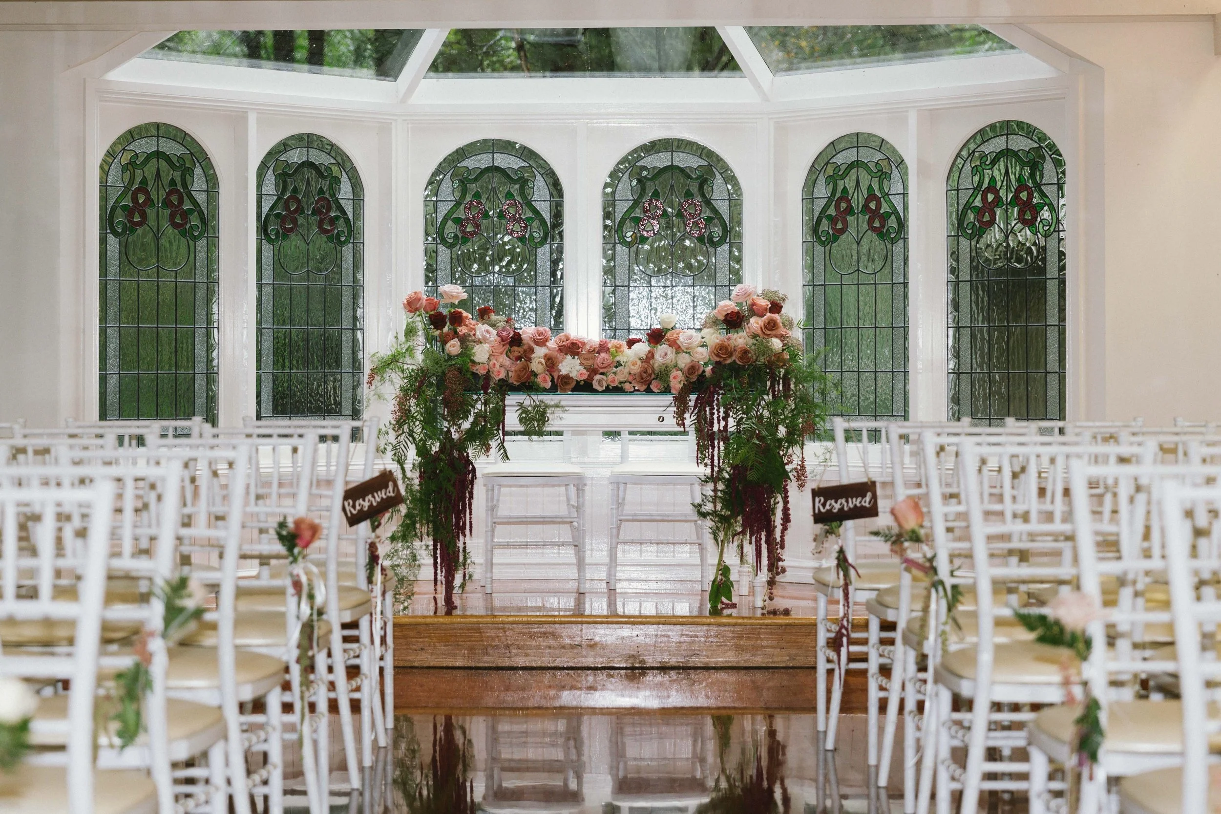 A romantic setting for R &amp; J at Lyrebird Falls Chapel. 🤍

Softly illuminated by natural light, the chapel&rsquo;s stained glass cast a beautiful glow across the space &mdash; creating an intimate and timeless setting for their vows.

Delicate fl