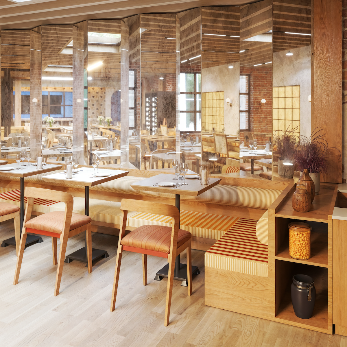 Interior of a modern restaurant with wooden furniture, tables set with glasses and plates, and a glass partition reflecting the dining area, exposed brick walls, and a mix of chairs and benches with cushions.