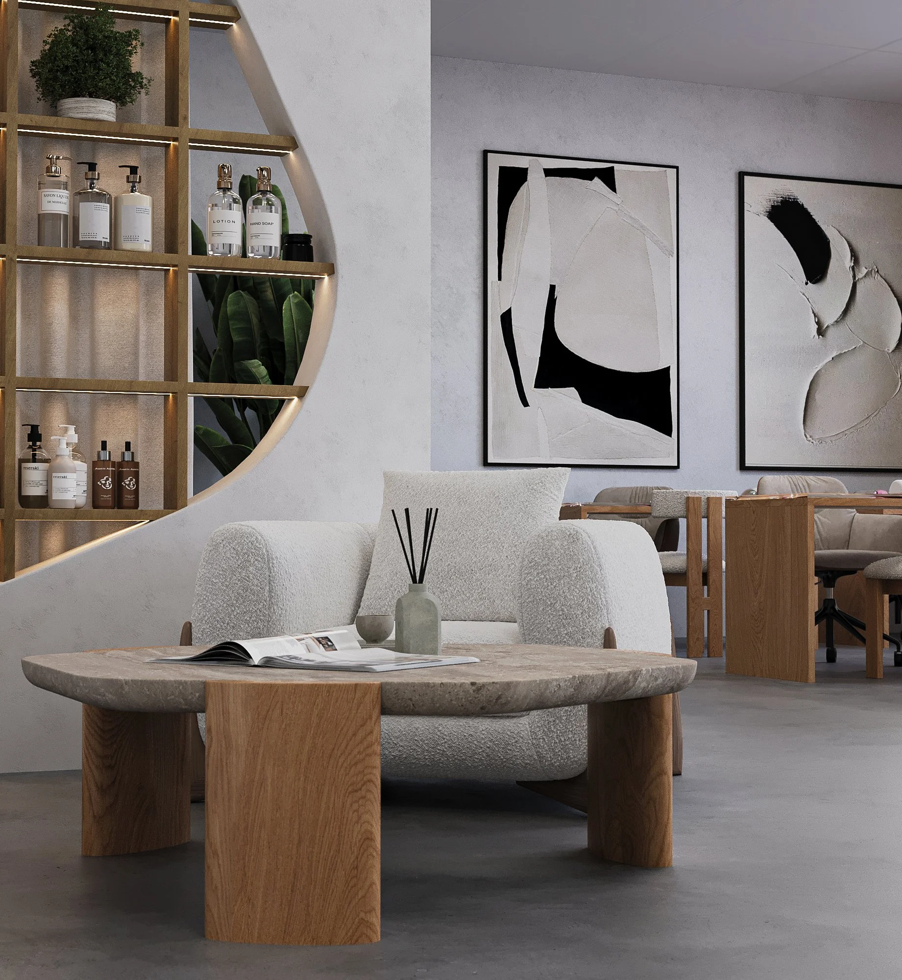 Modern living room with a beige sofa, a round coffee table with an open magazine, a white decorative vase with black fragrance sticks, wall art with black and white abstract designs, and a wooden shelving unit displaying bottles and plants.