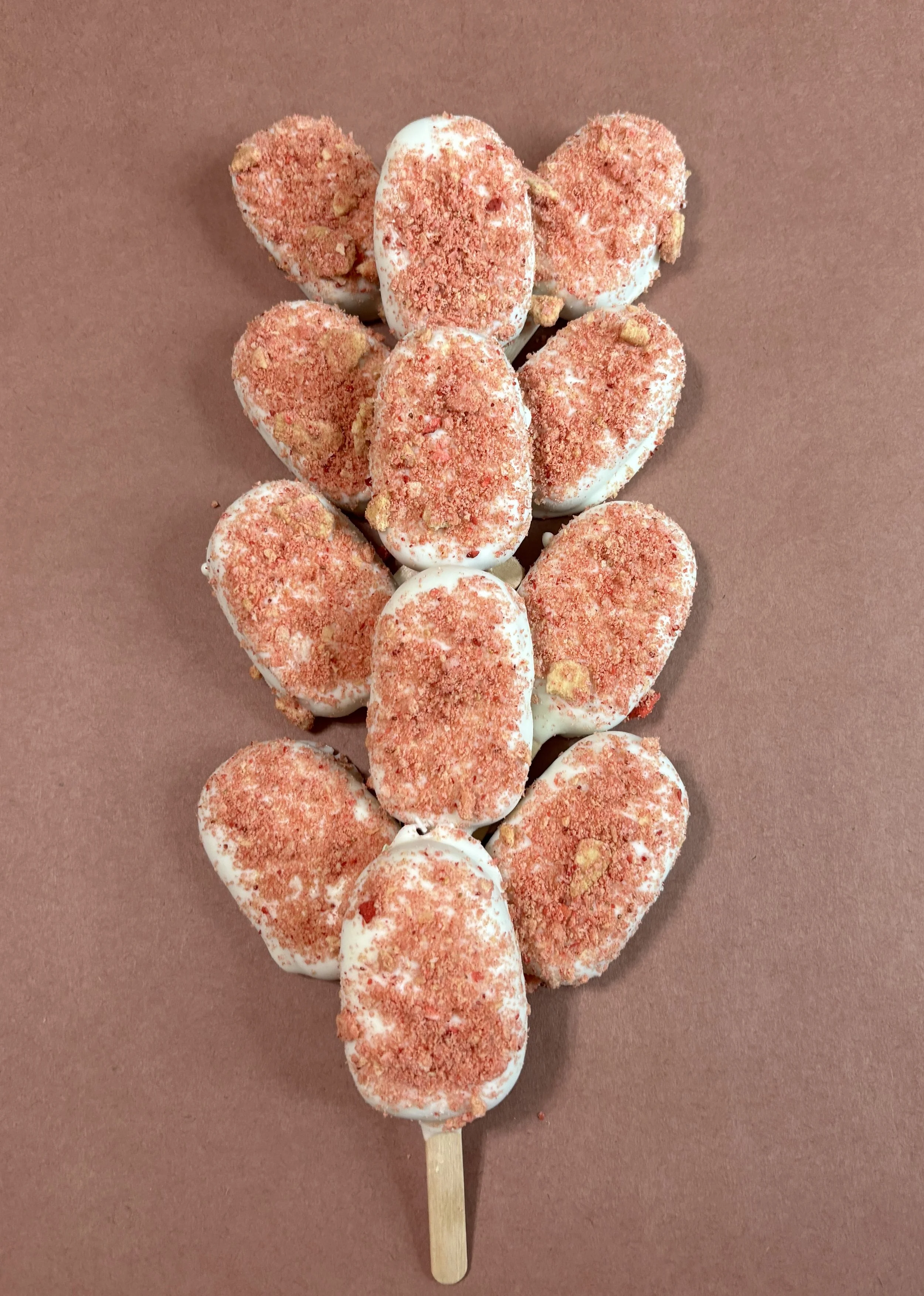 Strawberry shortcake a delicious strawberry cake covered in a vanilla candy coating and a homemade strawberry crumble. 