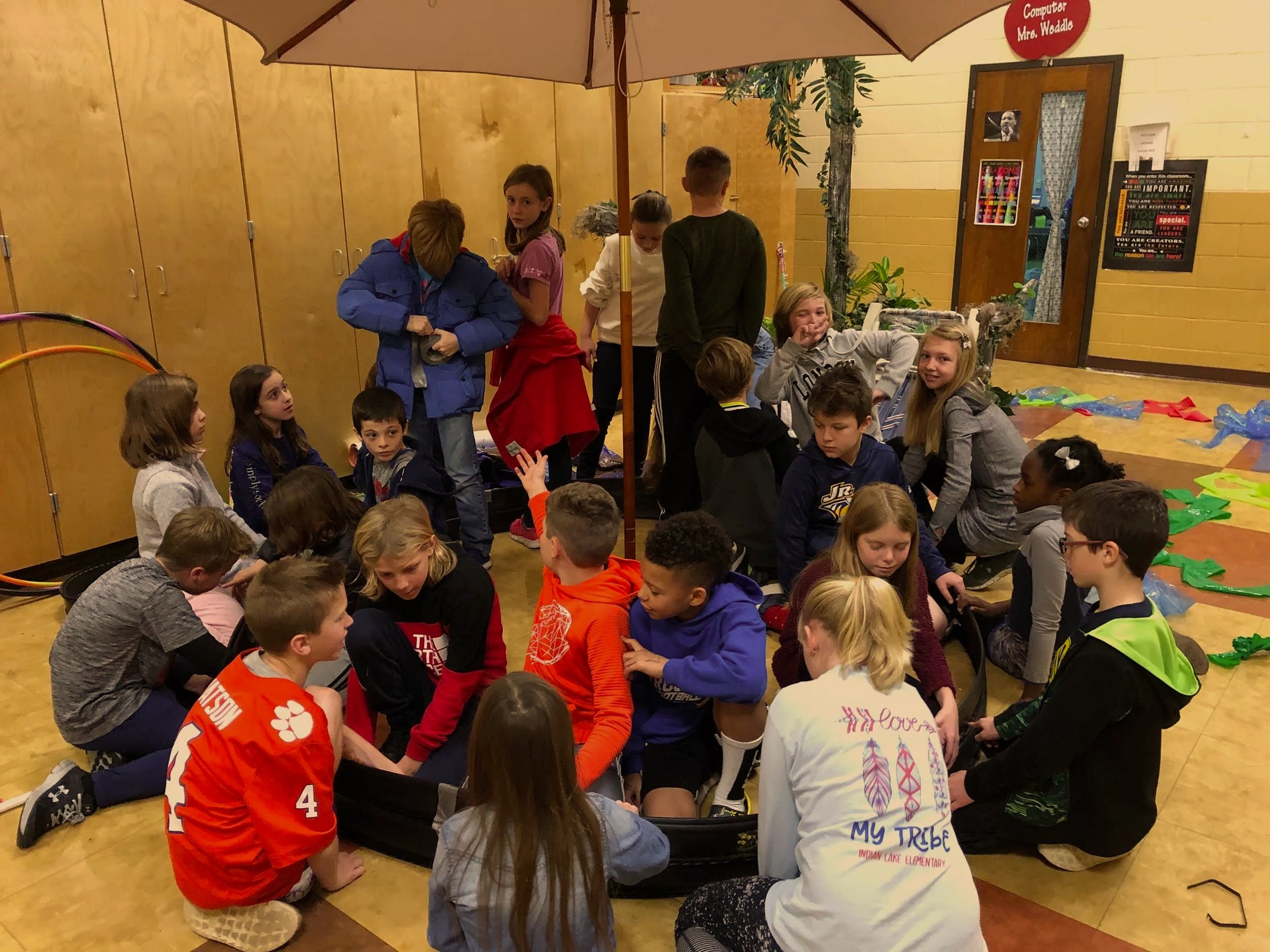 School students collaborating on an immersive arts activity in a classroom.