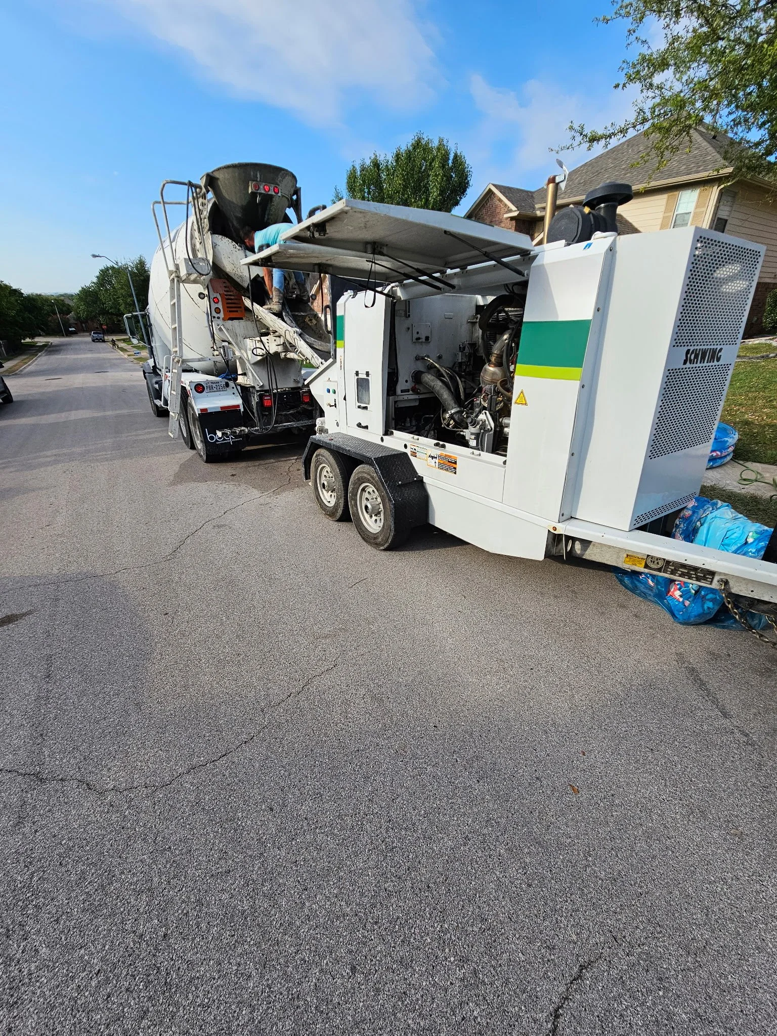 A concrete truck and pump ready to pour a concrete slab in Austin, TX