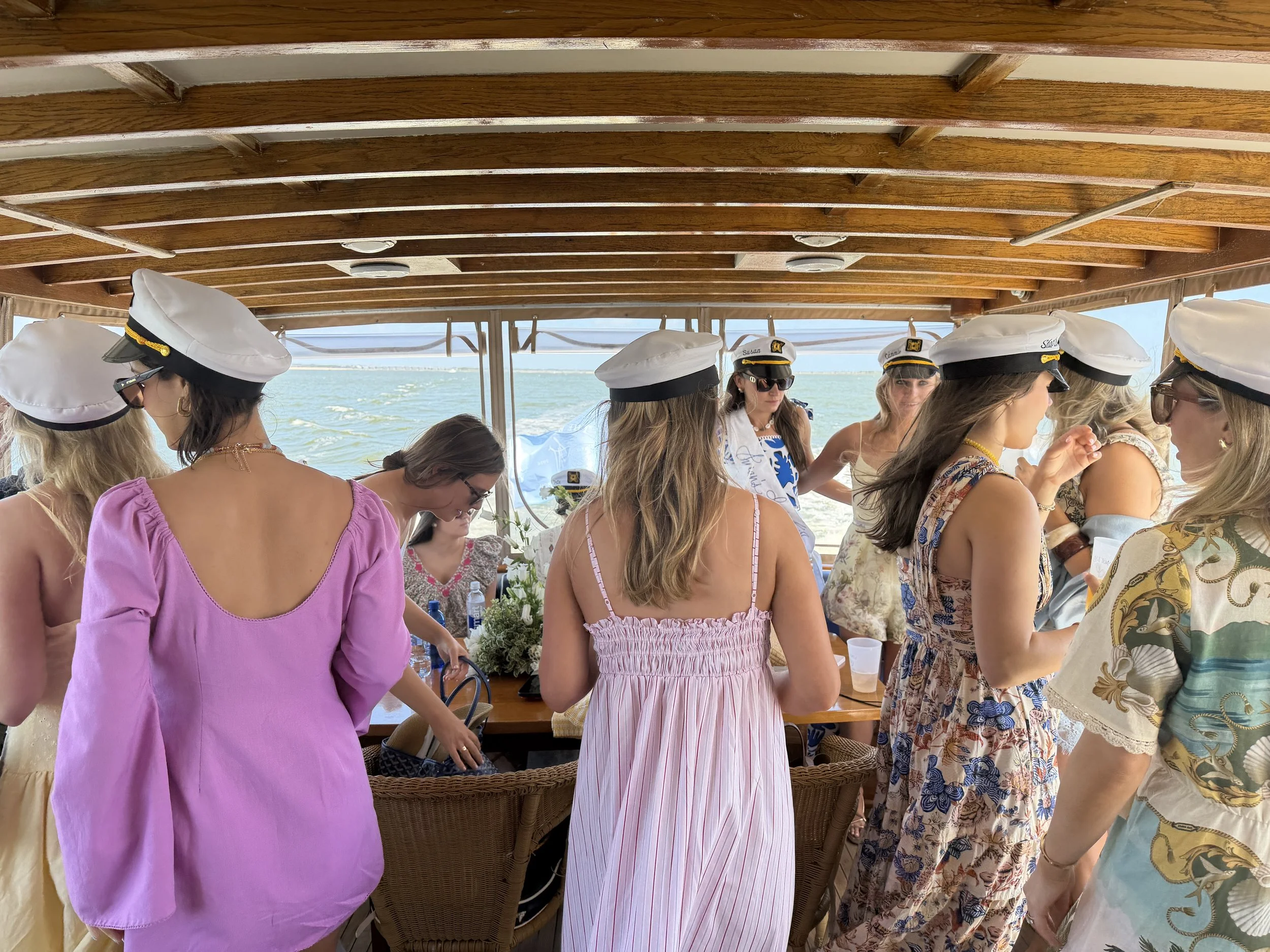 Bachelorette party in captain hats aboard String of Pearls