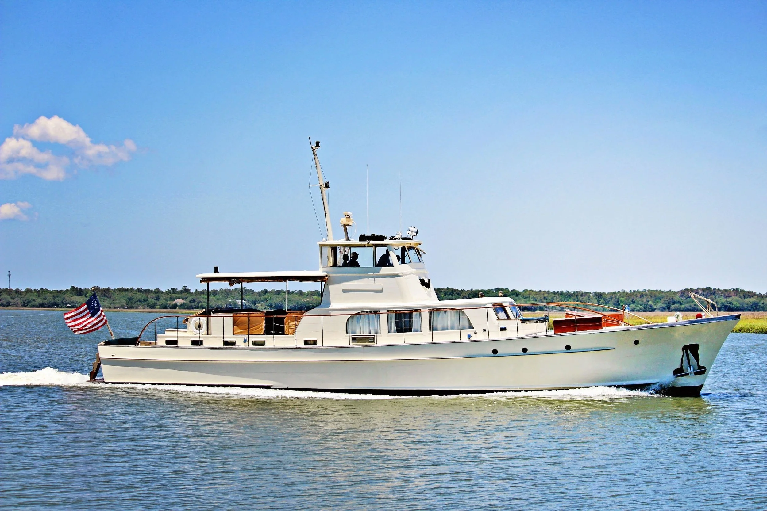 String of Pearls yacht underway under a blue sky