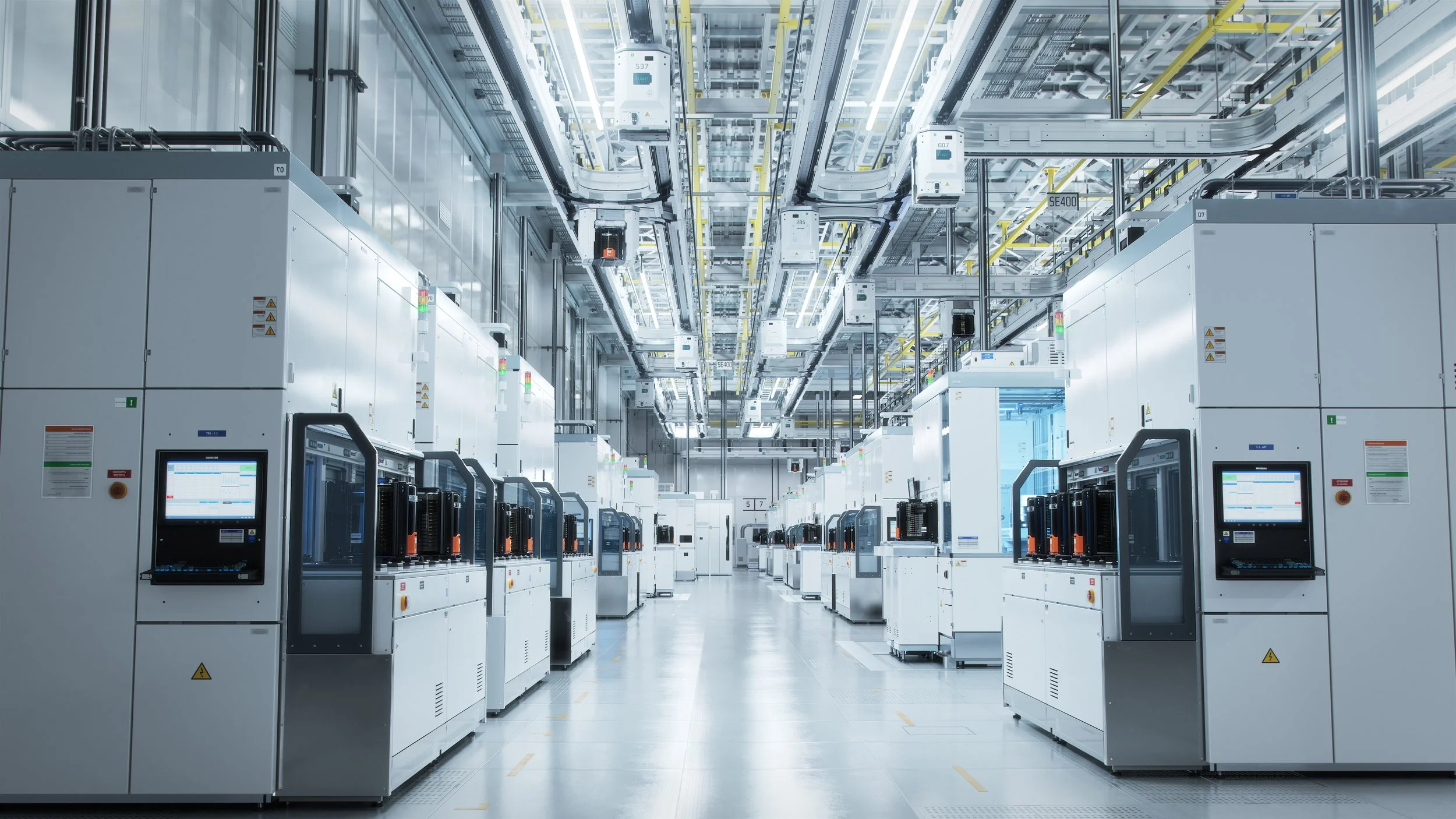 A clean, modern data center with rows of servers, cooling units, and extensive cabling.