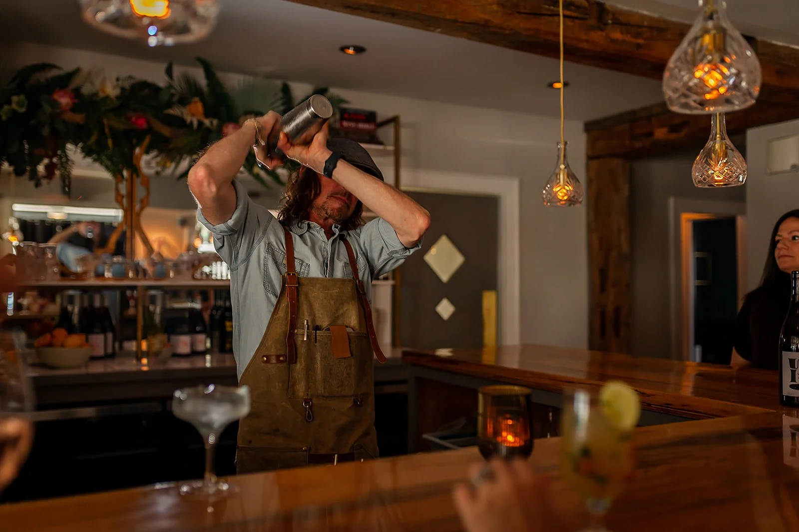 Mixologist Ian Budd crafting cocktails at the bar at Cork Restaurant in Stowe, Vermont