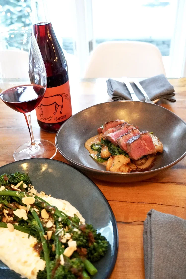 Seasonal steak dish with broccolini and natural red wine at Cork Restaurant in Stowe, Vermont