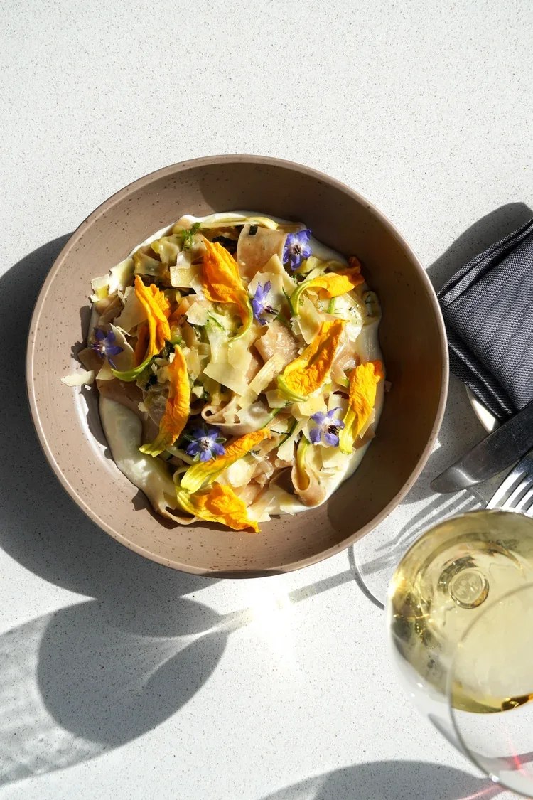House-made pasta with local squash blossoms and seasonal ingredients and natural wine at Cork Restaurant in Stowe, Vermont